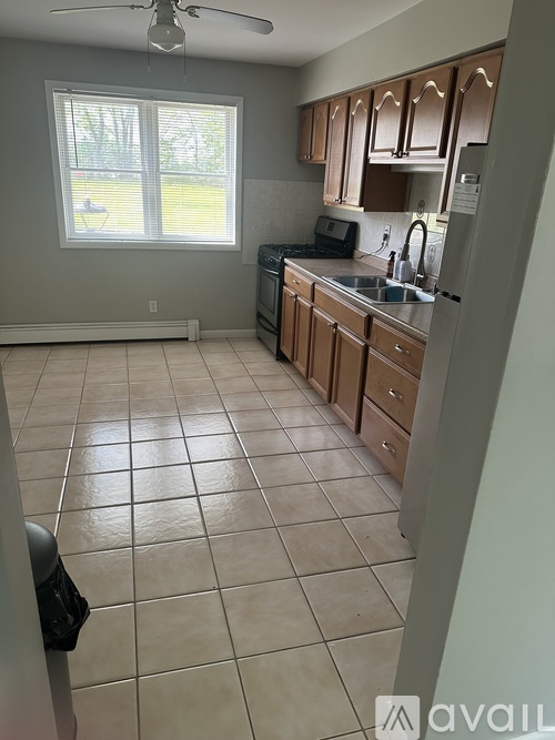A kitchen with a fan and a window.