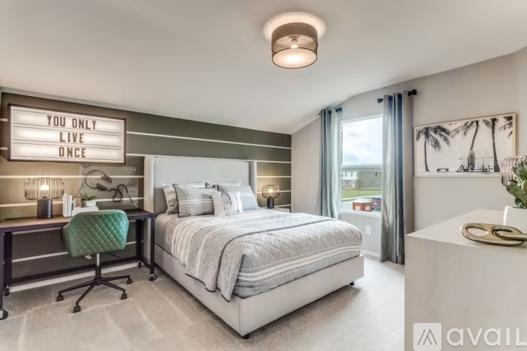 A bedroom with a bed, desk, and a sign that says "You only live once".