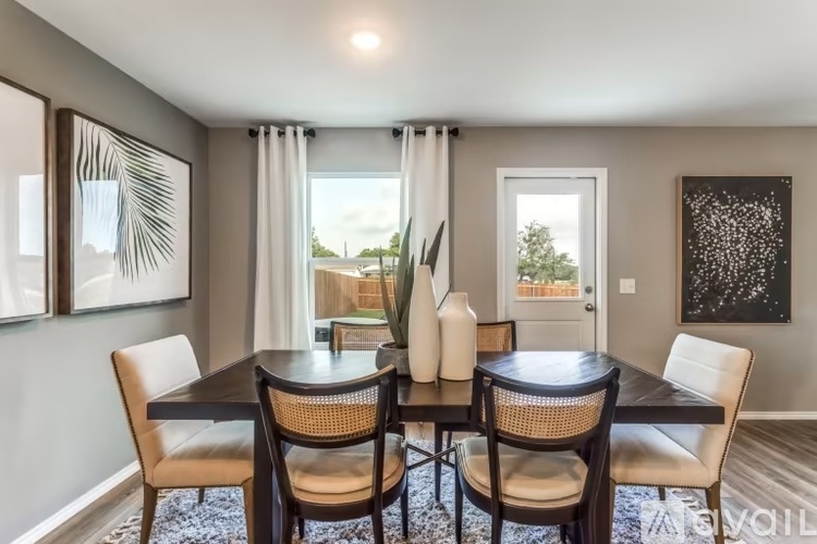 A dining room with a table set for two.