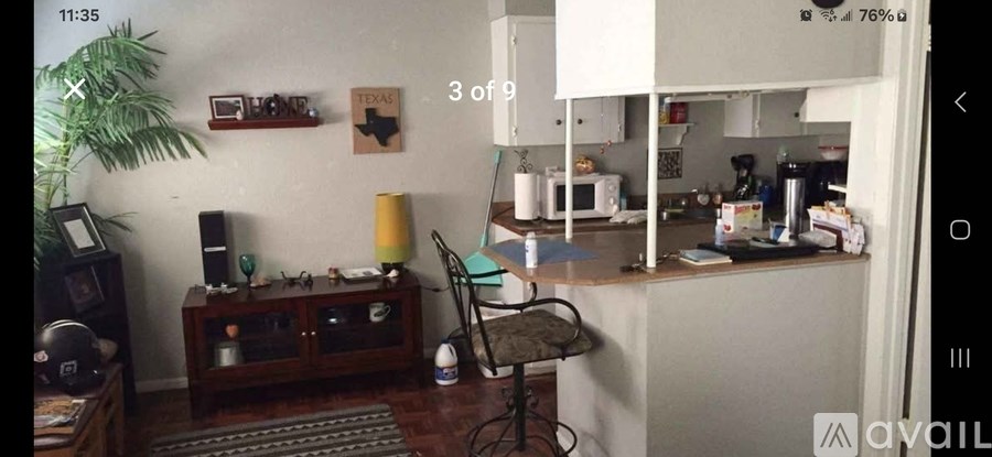 A room with a chair, a table, and a cabinet.