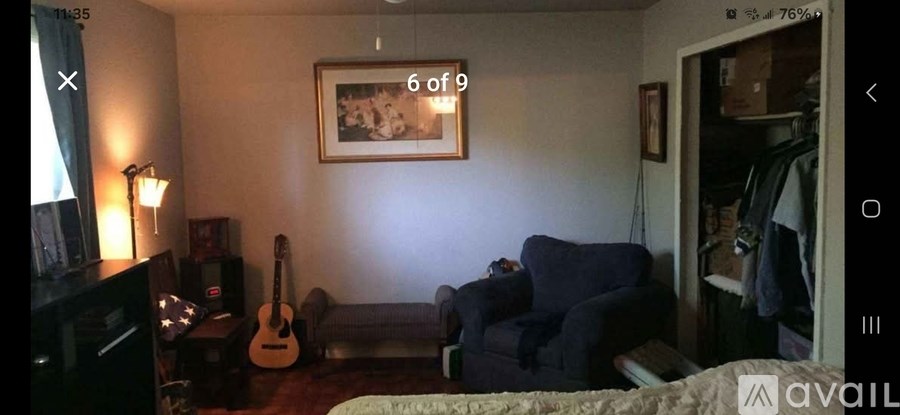 A living room with a guitar and a couch.