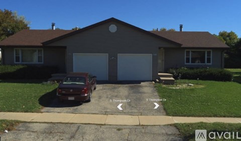 A house with a brown roof and a garage door is shown.