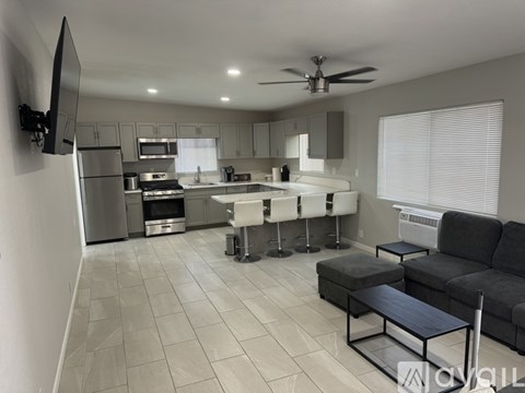 A modern kitchen with a dining table and chairs.