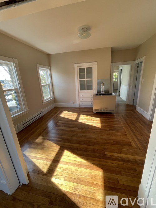 A room with wooden floors and a white door.