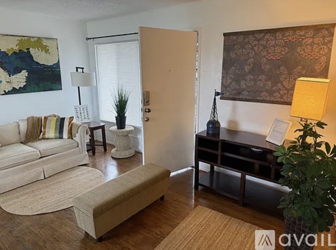 A room with a ceiling fan and a window with blinds.
