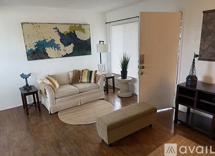 A room with a ceiling fan and wooden flooring.