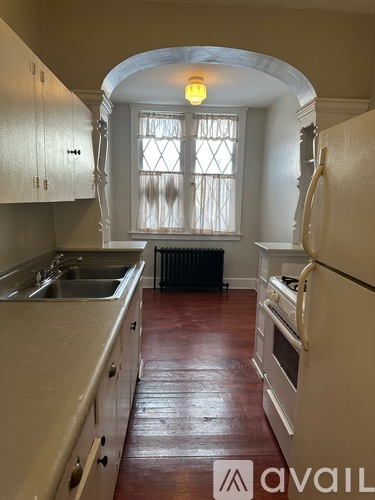 A kitchen with a sink, stove, and refrigerator.