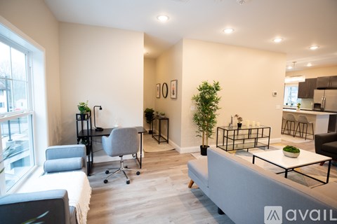 A living room with a grey sofa and a glass coffee table.
