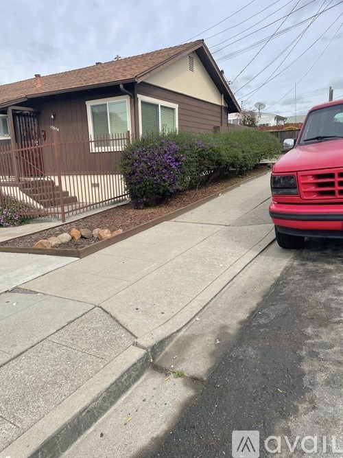 A red truck is parked on the side of a street.