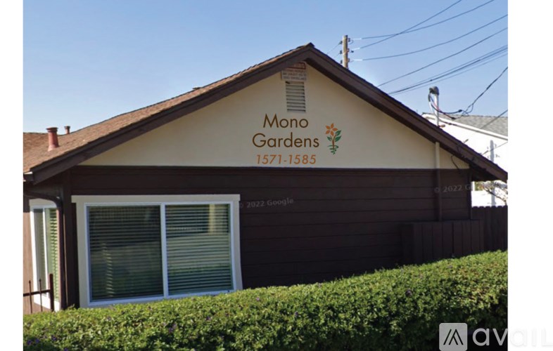 A building with a sign that says Mono Gardens.