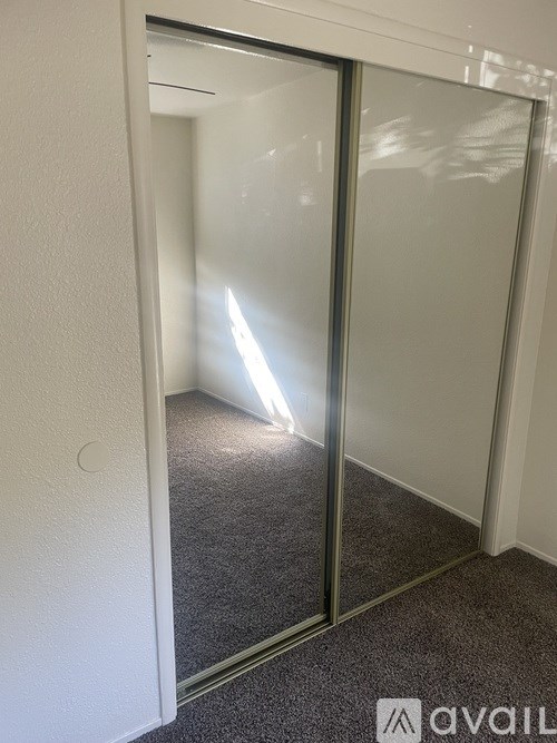A room with a carpeted floor and a glass door.