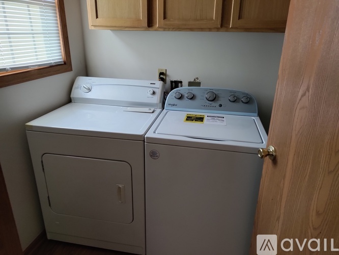 A white washing machine and dryer in a small laundry room.