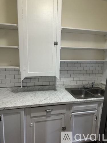 A kitchen with a sink and cabinets.