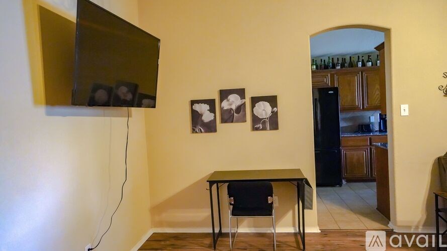 A living room with a black chair and a small table.