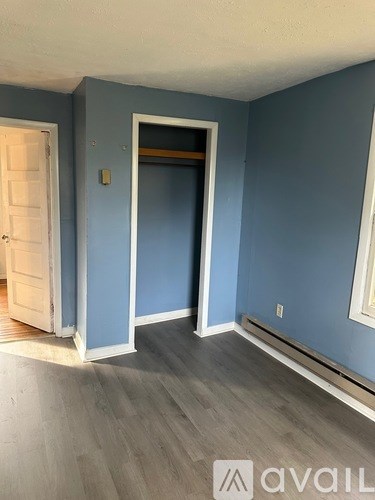 A room with blue walls and a white door.