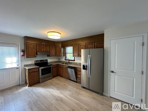 A kitchen with wooden cabinets and stainless steel appliances.