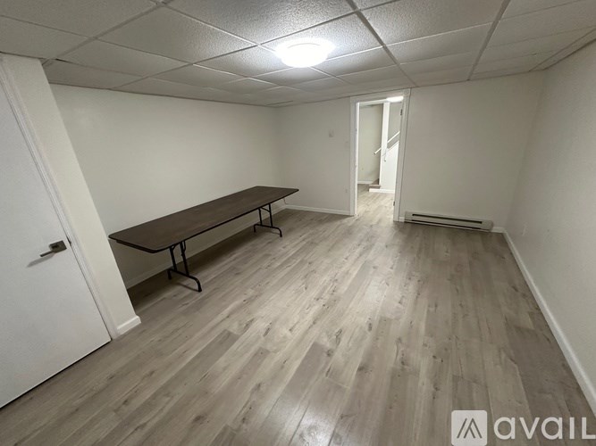 A room with a long table and a white door.