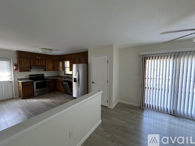 A kitchen with wooden cabinets and a white refrigerator.