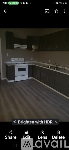 A kitchen with a white oven and wooden flooring.