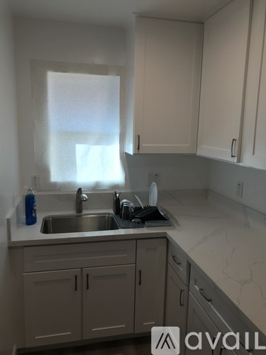 A kitchen with a sink and cabinets.