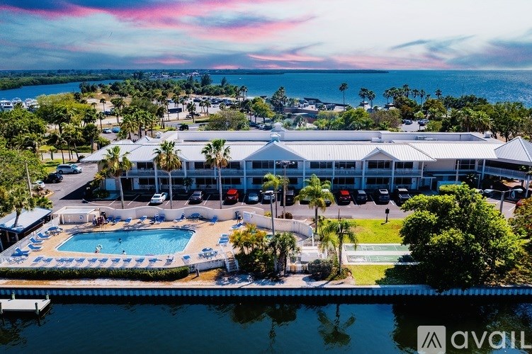 A large building with a pool in front of it.