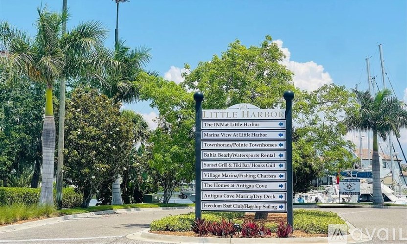A signpost lists various businesses in Little Harbor.