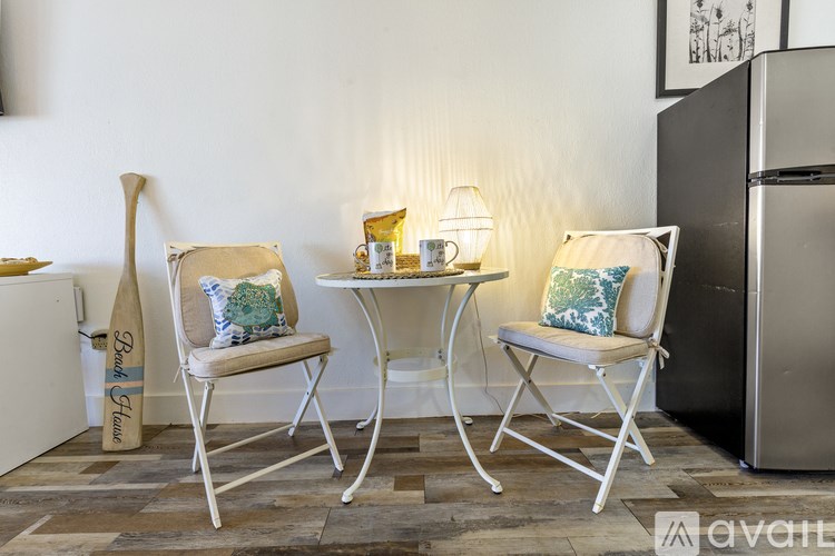 Two chairs and a table are in a room.