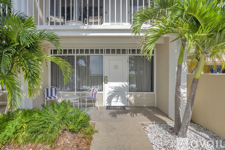A balcony with a white railing and a white door.