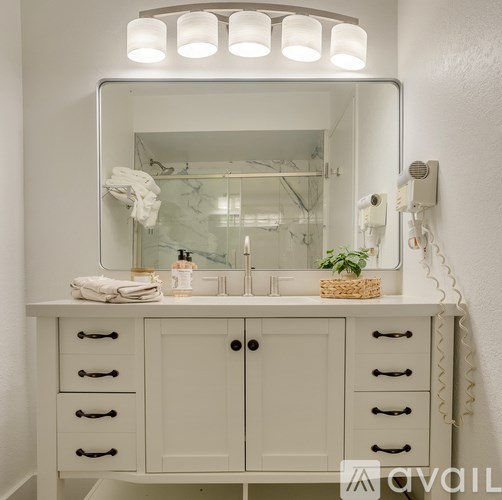 A bathroom vanity with a mirror above it.