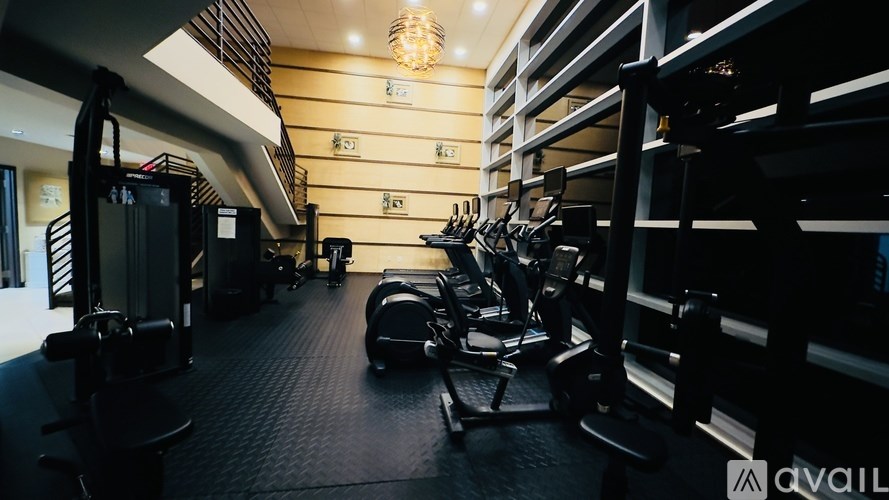A gym with treadmills, elliptical machines, and other exercise equipment.