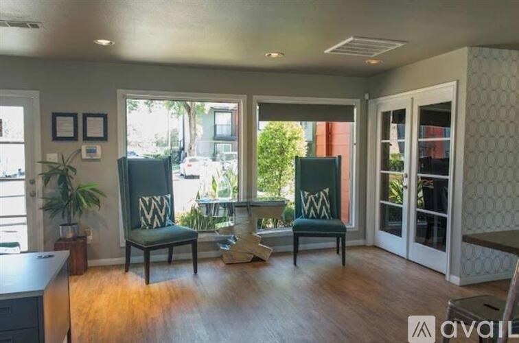 A living room with two chairs and a table.