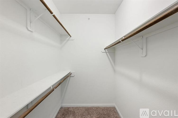 A small, empty room with a carpeted floor and white walls.