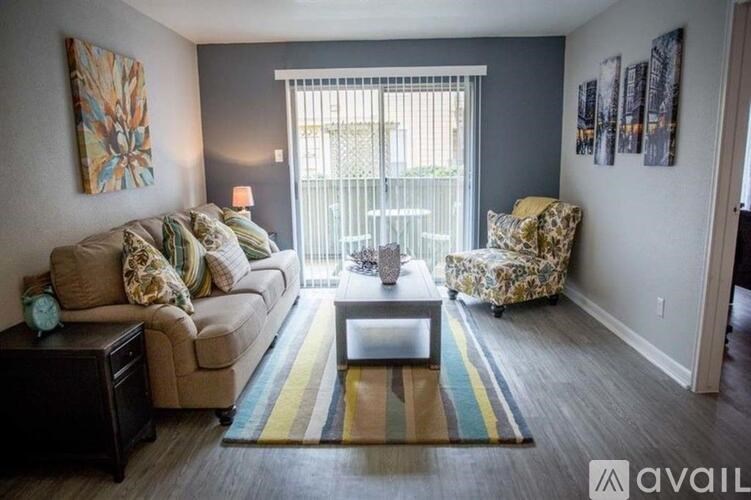 A living room with a couch, chair, and coffee table.