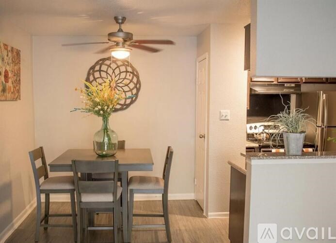A dining room with a table set for four.