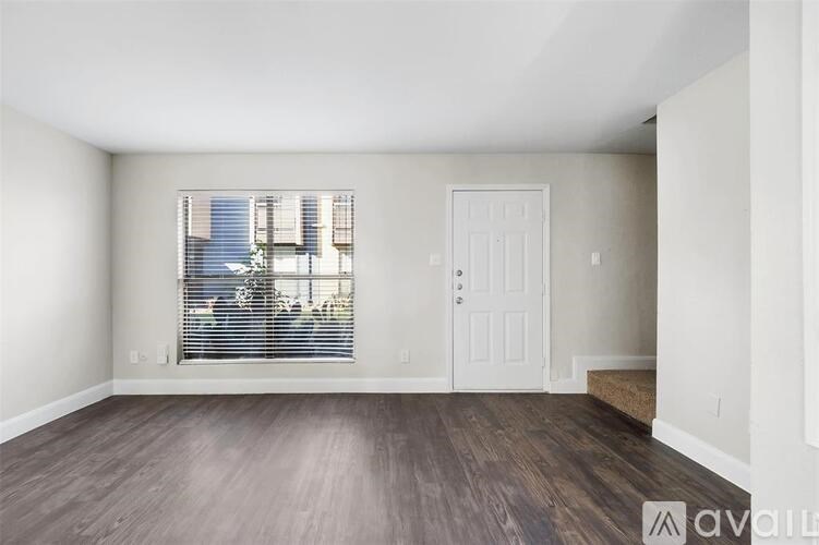 A room with a window and a door is available for rent.