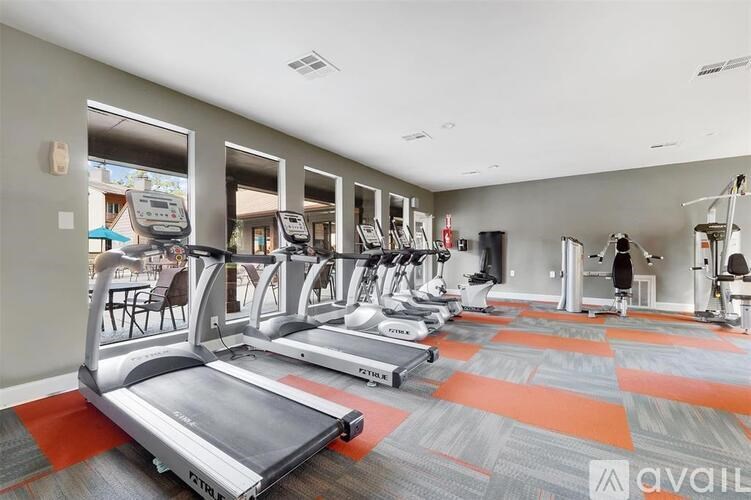 A gym with treadmills and exercise equipment.