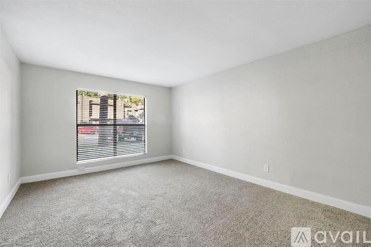A room with a window showing a street view outside.