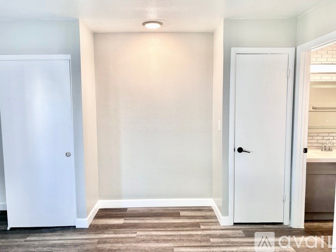 A white door is open to a bathroom.