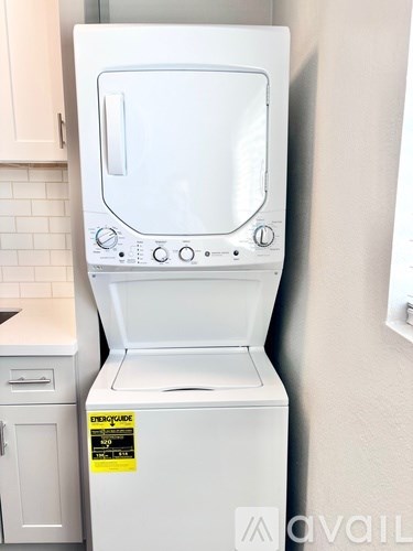 A white dishwasher with a yellow sticker on the door.