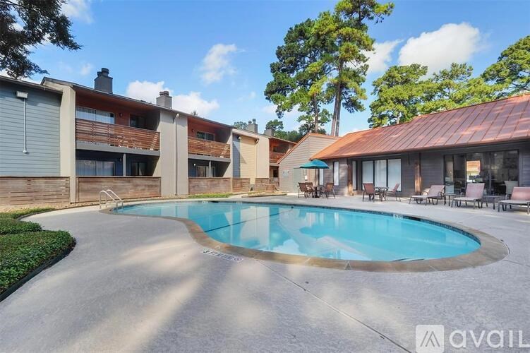A swimming pool in a backyard surrounded by a patio and a house.