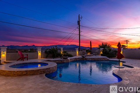 A pool with a sunset in the background.