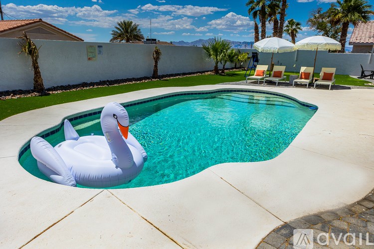 A pool with a white inflatable duck in it.