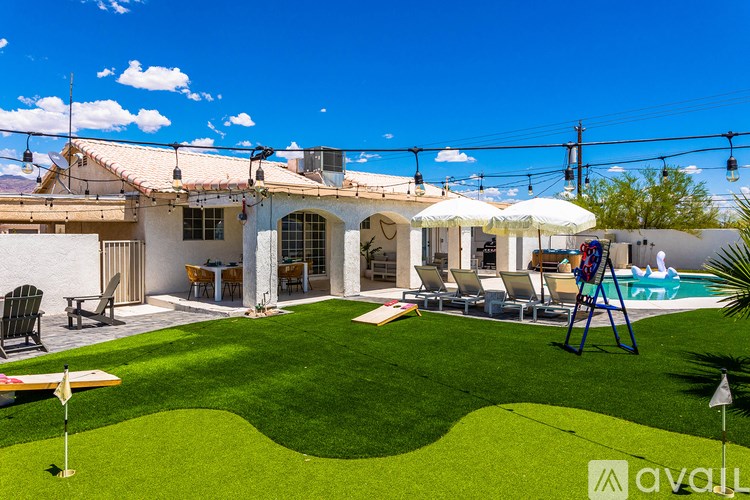 A house with a pool and a lawn.