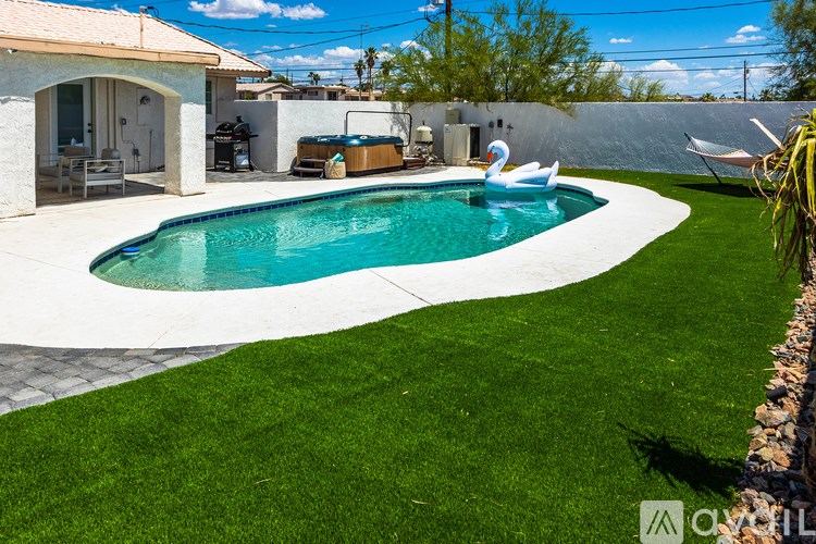 A pool with a white inflatable flamingo in it.