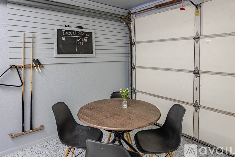 A chalkboard sign in a garage that says "Boys Girls".