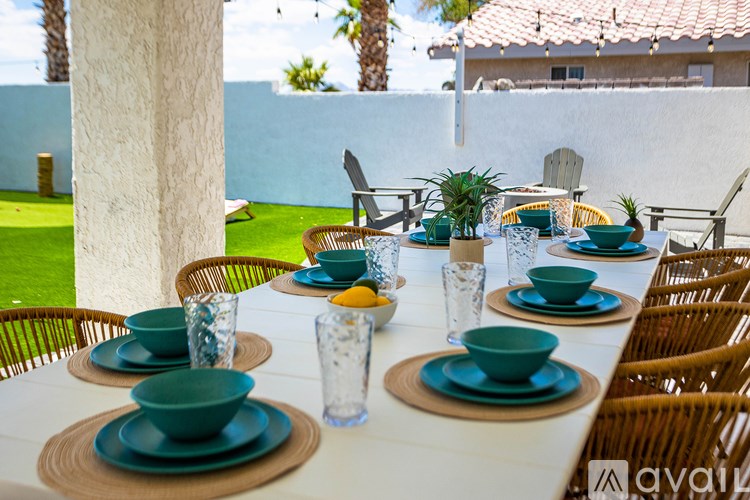 A table set for a meal with green plates and glasses.