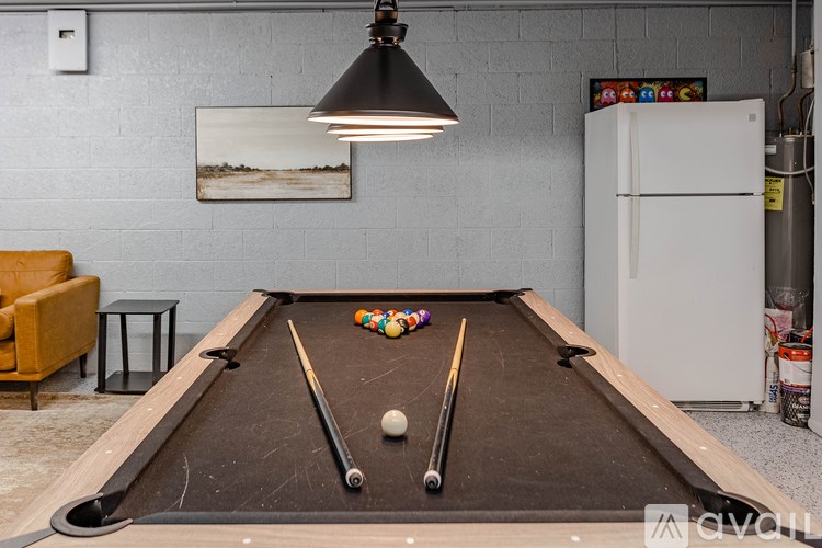 A pool table with a white ball and two cue sticks on it.