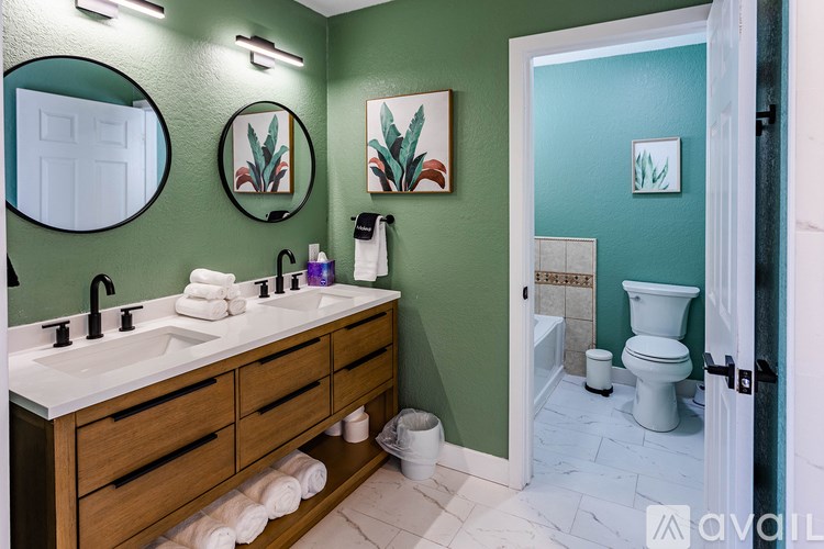 A bathroom with green walls and a white sink.