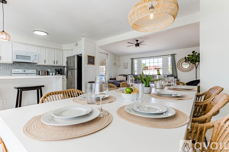 A dining room with a table set for two.