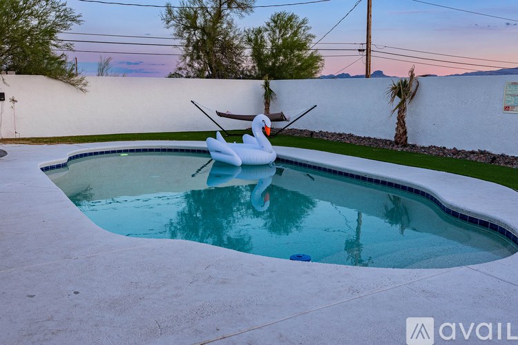A pool with a snowman statue in the middle of it.